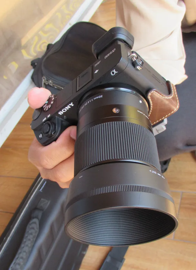 Sony a6400 camera body with a third-party Sigma 30mm lens attached